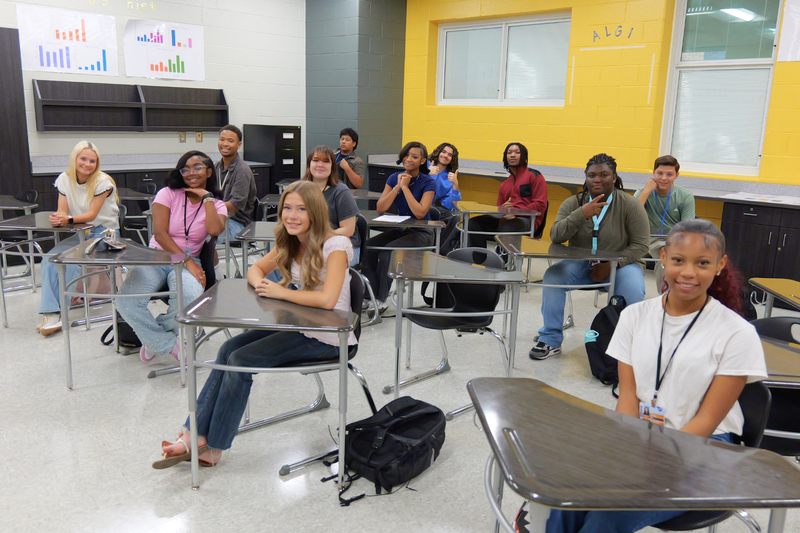 Students sitting attentively at their desks during filming.