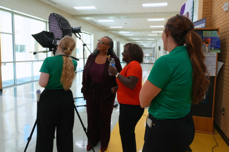 Communications team reviewing footage with board members.