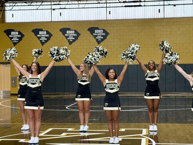 North Augusta High Cheerleaders practice in school gym.