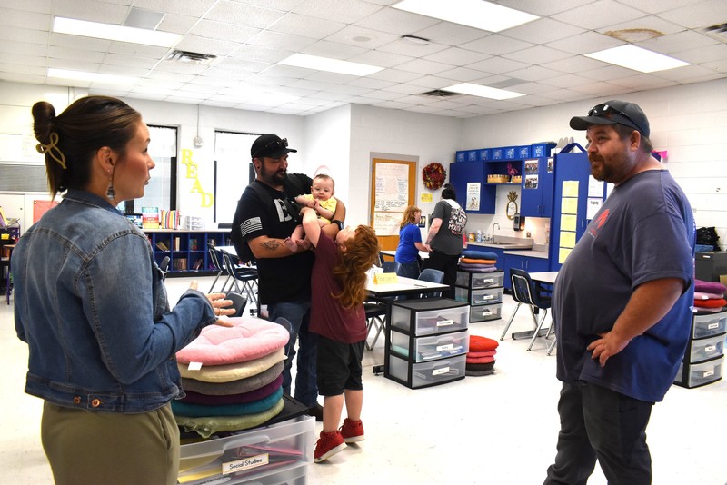 Families talking with teachers.