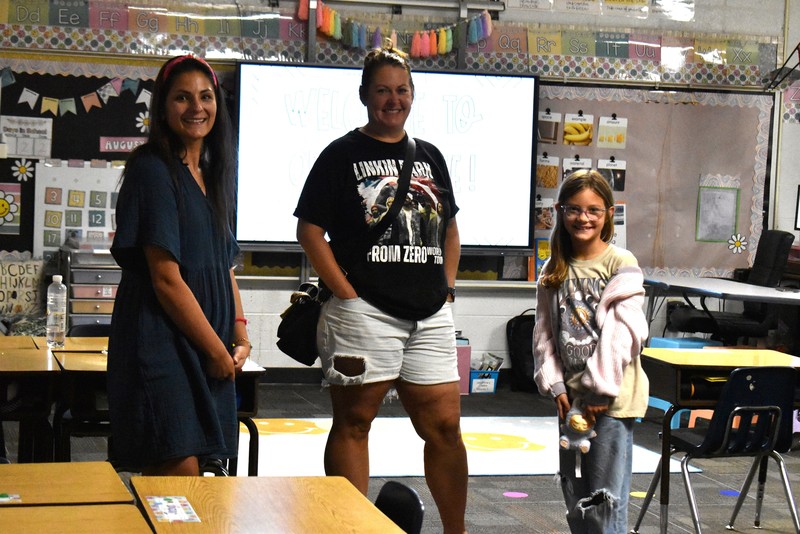 Families talking with teachers.
