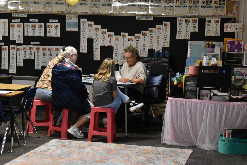 Families talking with teachers.