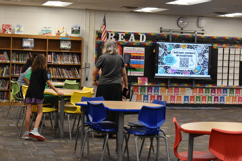 Families talking with teachers.