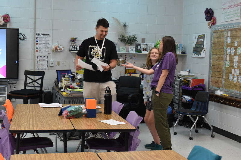 Families talking with teachers.