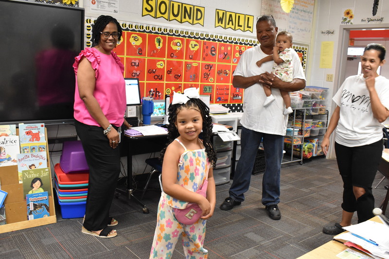 Families talking with teachers.