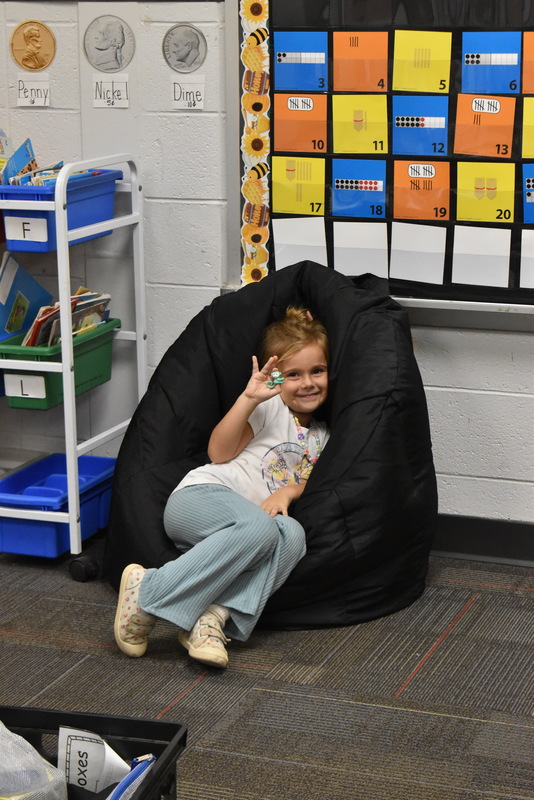 Girl sittin on bean bag.