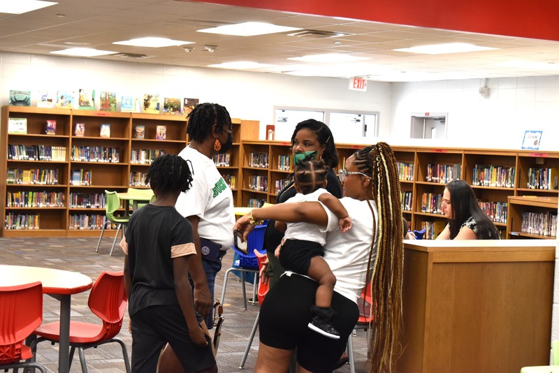 Families talking with teachers.