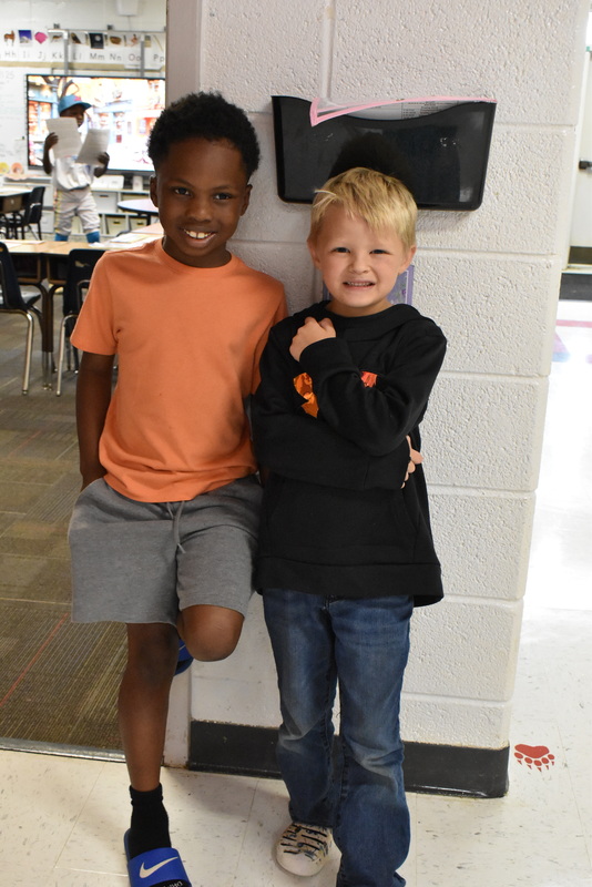 Two boys standing by classroom.