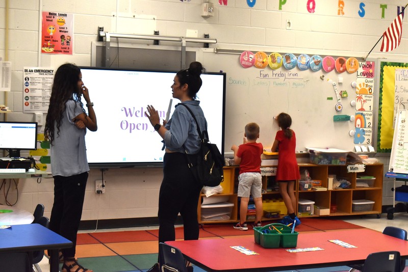 Families talking with teachers.