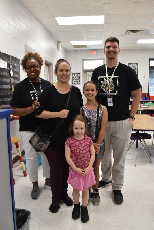 Families talking with teachers.