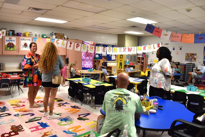 Families talking with teachers.