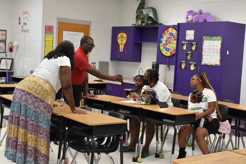 Families talking with teachers.