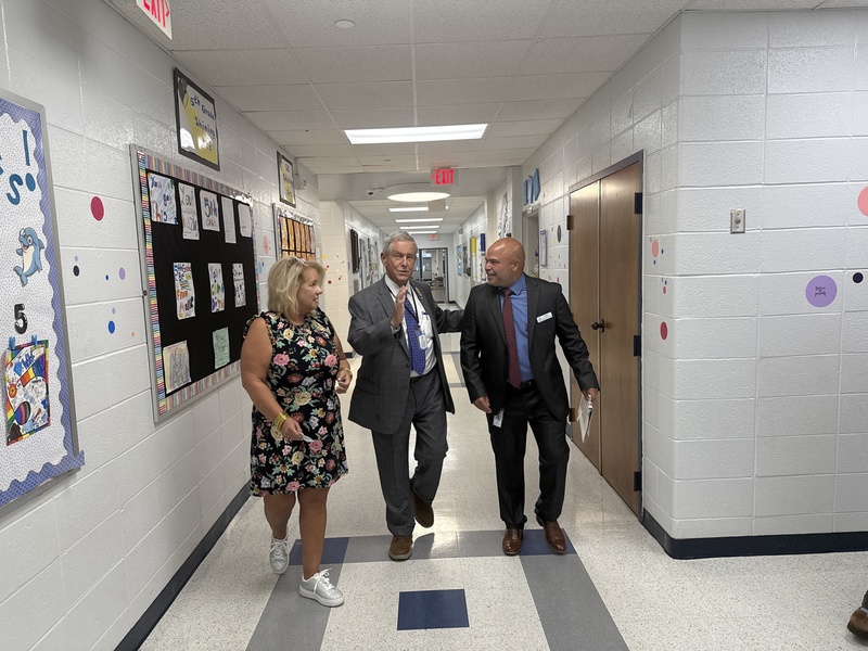 Congressman Wilson walks down hall with school leaders.
