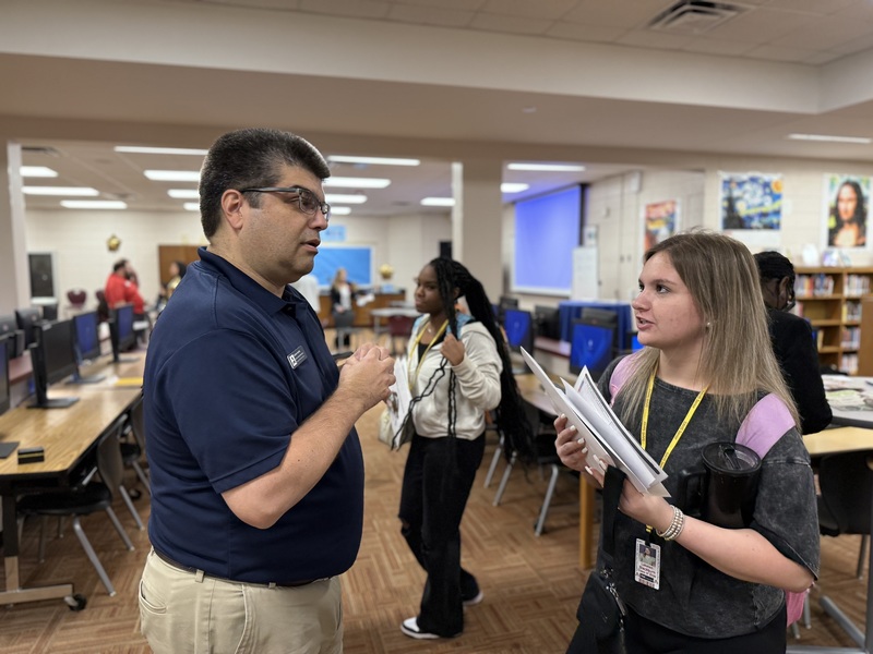 College representative speaks with high school student at South Aiken High. 