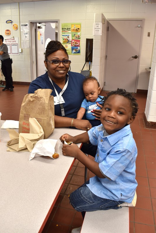 Grandparents and families at lunch with students.