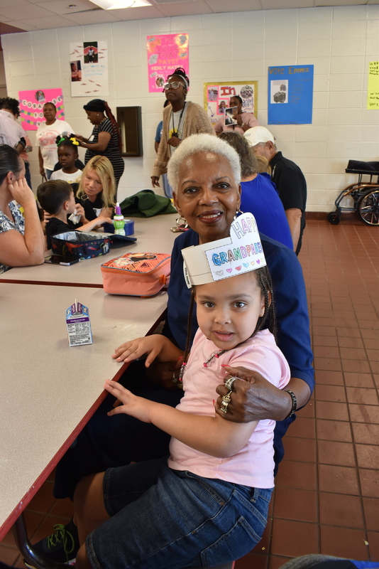 Grandparents and families at lunch with students.