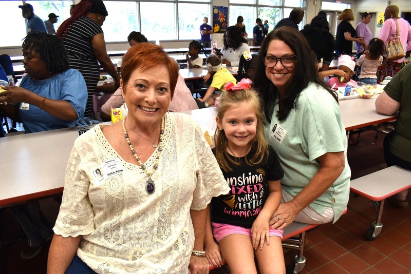 Grandparents and families at lunch with students.