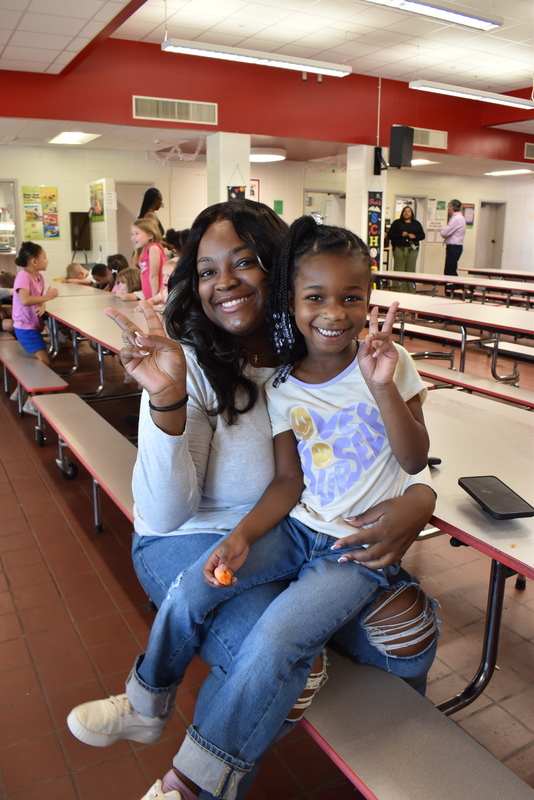 Grandparents and families at lunch with students.