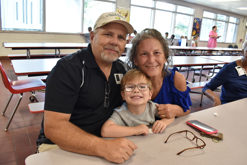 Grandparents and families at lunch with students.