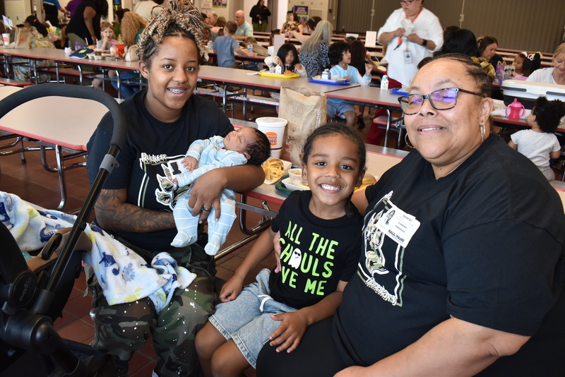 Grandparents and families at lunch with students.