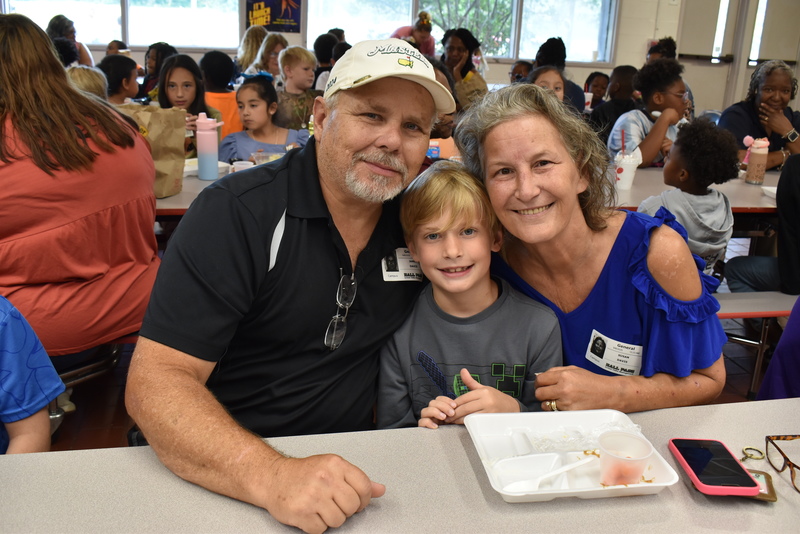 Grandparents and families at lunch with students.