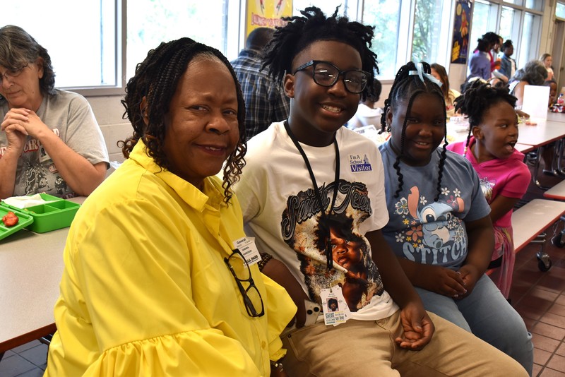 Grandparents and families at lunch with students.