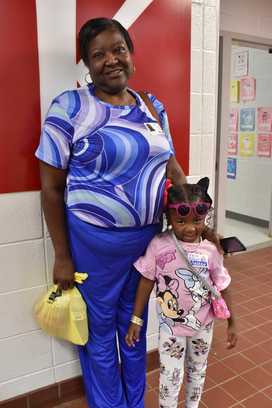 Grandparents and families at lunch with students.