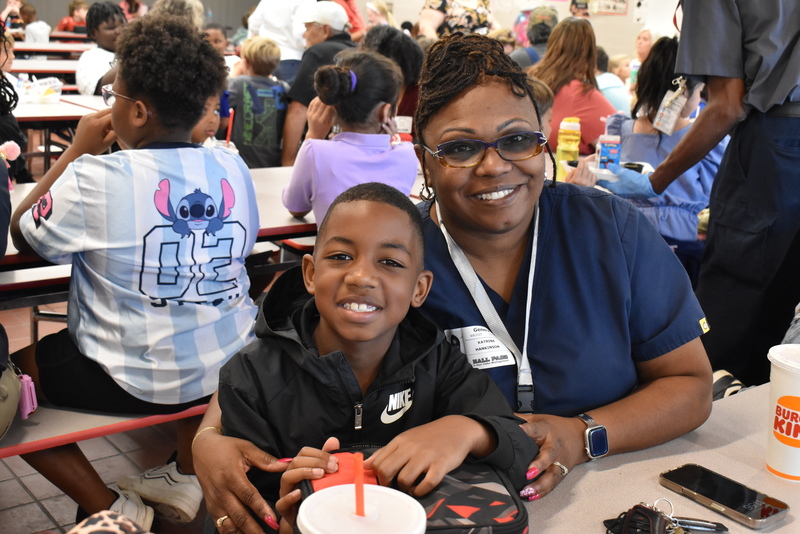 Grandparents and families at lunch with students.