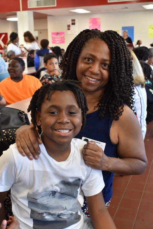 Grandparents and families at lunch with students.