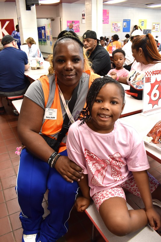 Grandparents and families at lunch with students.