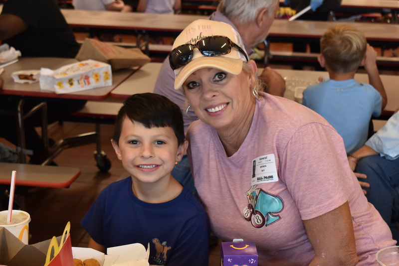 Grandparents and families at lunch with students.