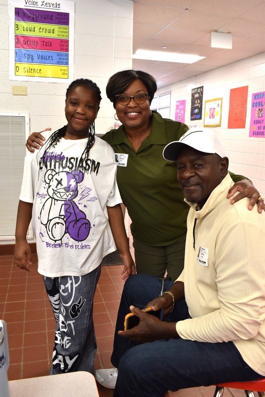 Grandparents and families at lunch with students.