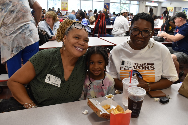 Grandparents and families at lunch with students.