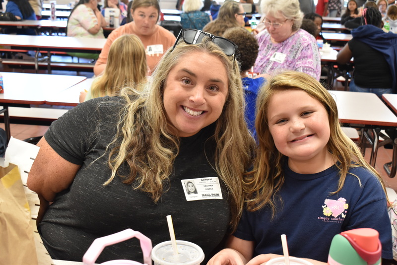 Grandparents and families at lunch with students.