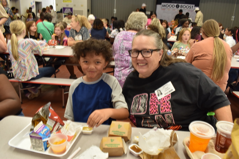 Grandparents and families at lunch with students.