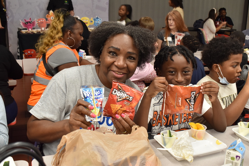 Grandparents and families at lunch with students.