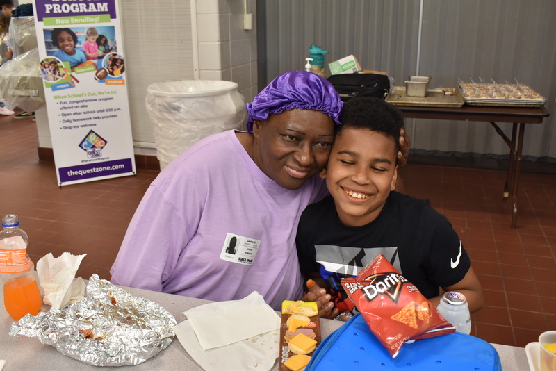 Grandparents and families at lunch with students.