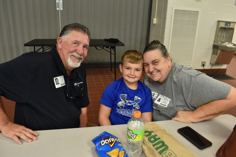 Grandparents and families at lunch with students.