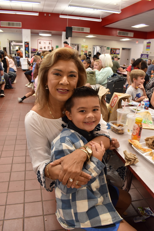 Grandparents and families at lunch with students.