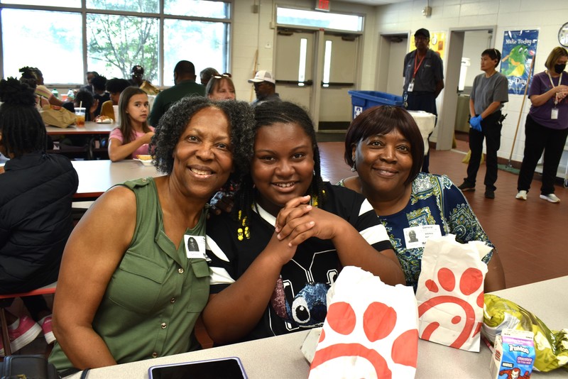 Grandparents and families at lunch with students.