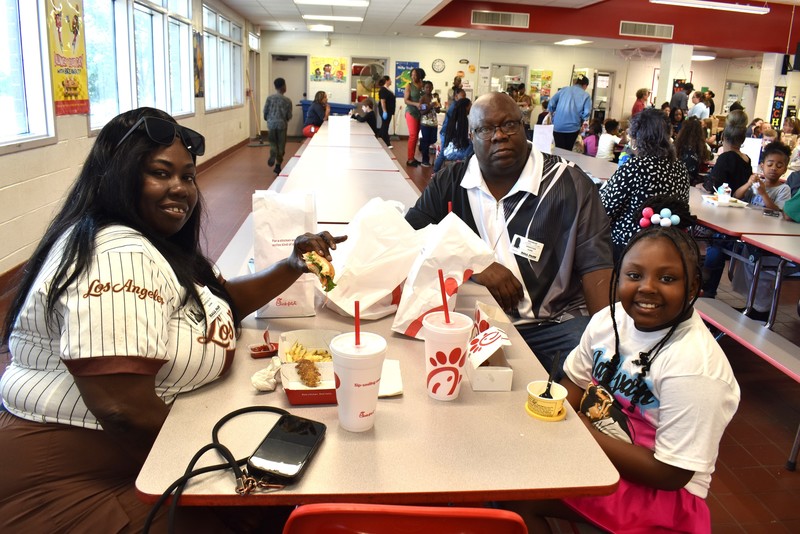 Grandparents and families at lunch with students.