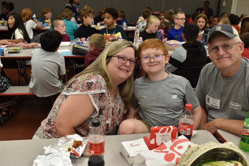 Grandparents and families at lunch with students.
