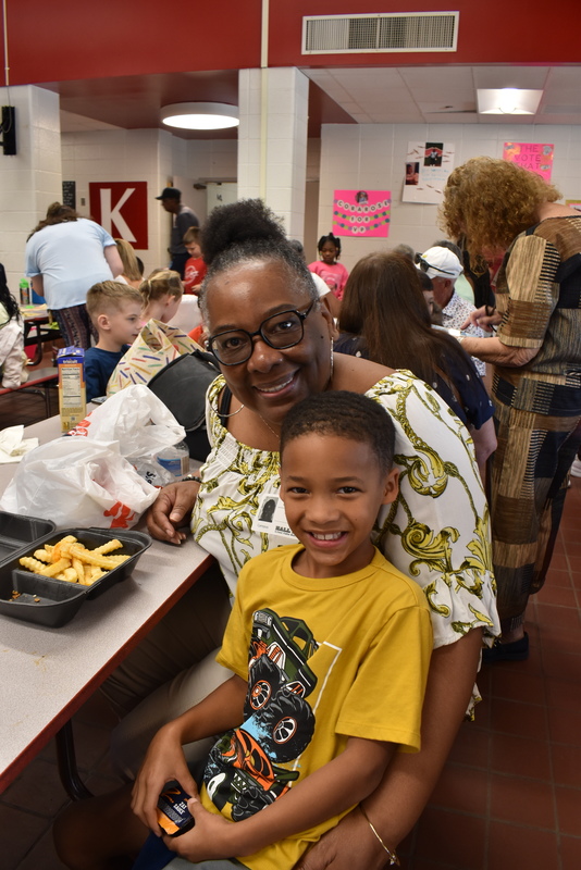 Grandparents and families at lunch with students.