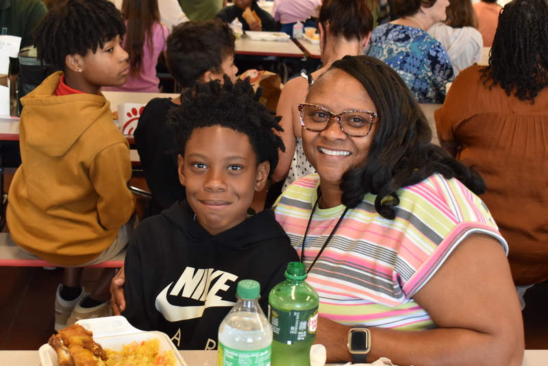 Grandparents and families at lunch with students.