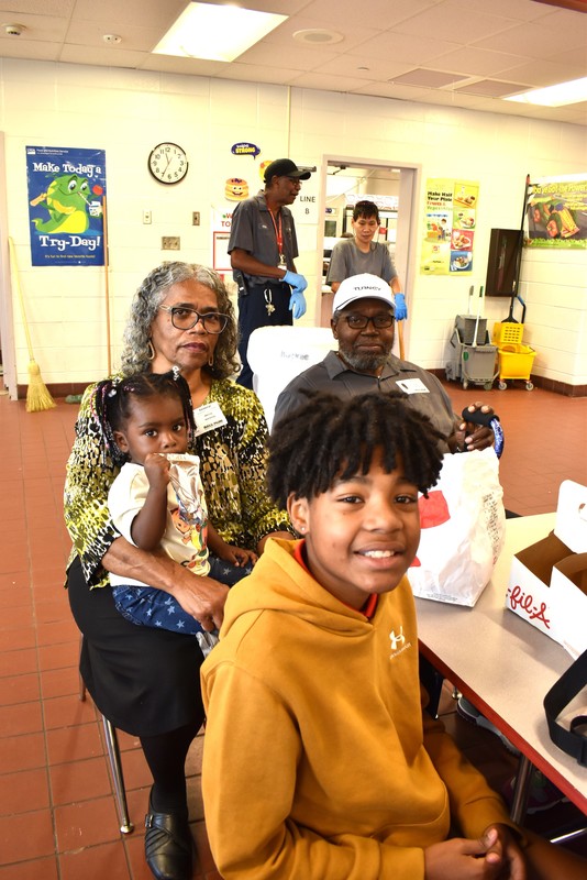 Grandparents and families at lunch with students.