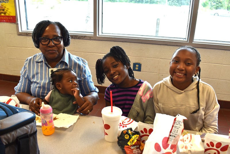 Grandparents and families at lunch with students.