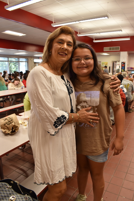 Grandparents and families at lunch with students.