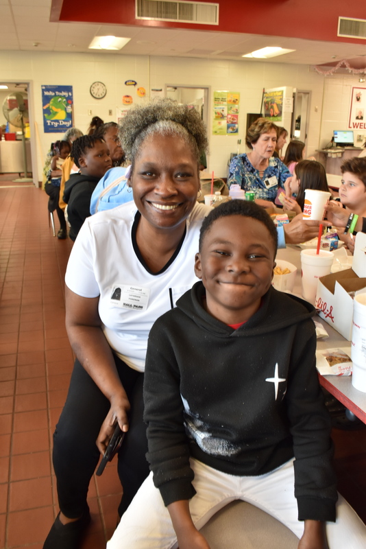 Grandparents and families at lunch with students.