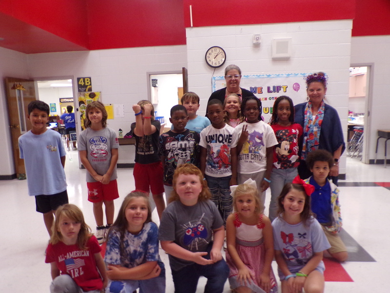 Students and staff wearing red, white, and blue.