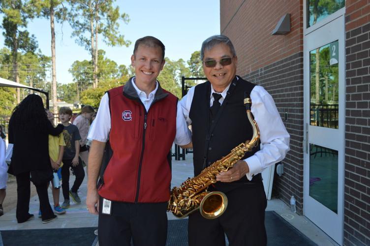 HHES staff member with Saxophonist Wayne Hoey.